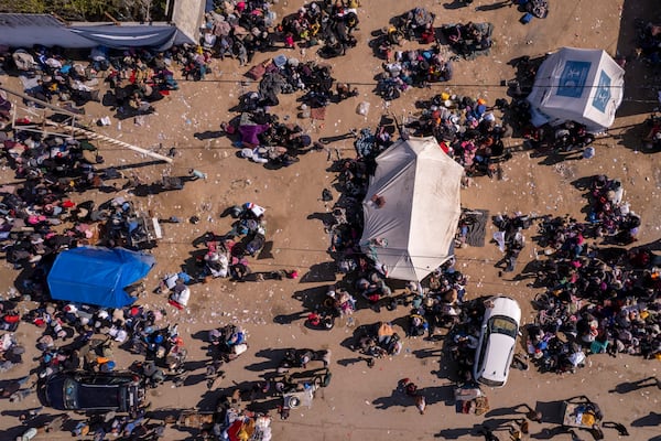 An aerial photograph taken by a drone shows displaced Palestinians gathering with their belongings near a roadblock on the al Rashid Street, as they wait to return to their homes in the northern part of the Gaza Strip, Sunday, Jan. 26, 2025, days after the ceasefire deal between Israel and Hamas came into effect. (AP Photo/Mohammad Abu Samra)