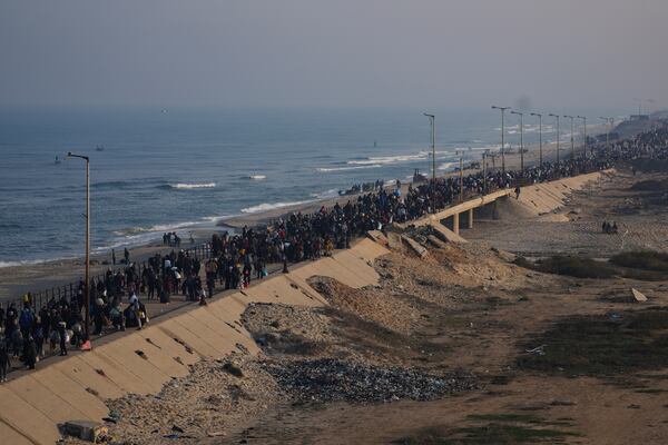 Displaced Palestinians walk on a road to return to their homes in the northern Gaza Strip, Tuesday, Jan. 28, 2025, after Israel's decision to allow thousands of them to go back for the first time since the early weeks of the 15-month war with Hamas. (AP Photo/Abdel Kareem Hana)