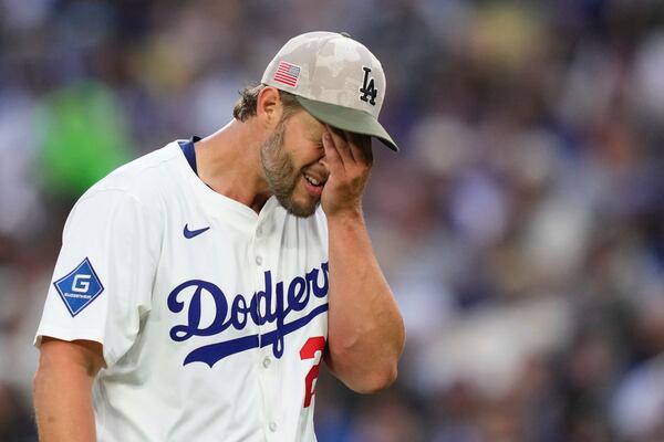 Los Angeles Dodgers starting pitcher Clayton Kershaw wipes his face after the top of the third inning of a baseball game against the Los Angeles Angels, Saturday, May 17, 2025, in Los Angeles. (AP Photo/Mark J. Terrill)
