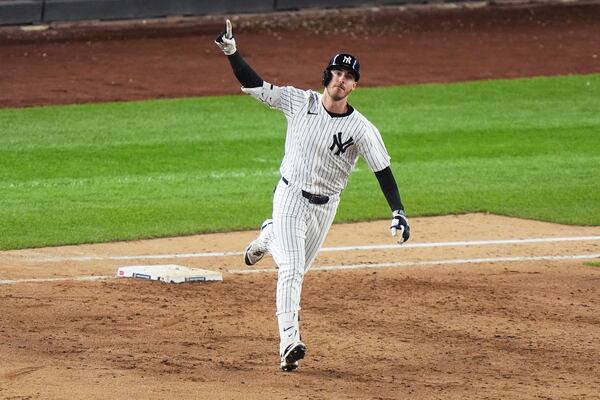 New York Yankees' Cody Bellinger gestures as he runs the bases after hitting a grand slam during the eighth inning of a baseball game against the New York Mets Sunday, May 18, 2025, in New York. (AP Photo/Frank Franklin II)
