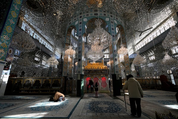 Syrians pray at the shrine of al-Sayydah Zeinab, the grand daughter of Prophet Mohammed, south of Damascus, Syria, Wednesday, Dec. 18, 2024. (AP Photo/Hussein Malla)