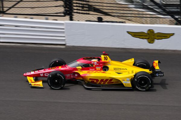 Alex Palou, of Spain, drives into the first turn during practice for the Indianapolis 500 auto race at the Indianapolis Motor Speedway in Indianapolis, Monday, May 19, 2025. (AP Photo/Michael Conroy)