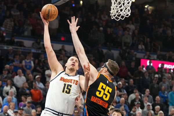 Denver Nuggets center Nikola Jokic (15) shoots over Oklahoam City Thunder center Isaiah Hartenstein (55) during the first half of an NBA basketball game, Sunday, March 9, 2025, in Oklahoma City. (AP Photo/Kyle Phillips)