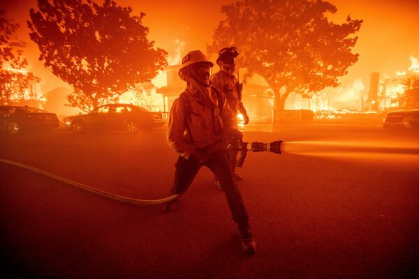 FILE - Firefighters battle the Palisades Fire as it burns multiple structures in the Pacific Palisades neighborhood of Los Angeles, Tuesday, Jan. 7, 2025. (AP Photo/Ethan Swope, File)