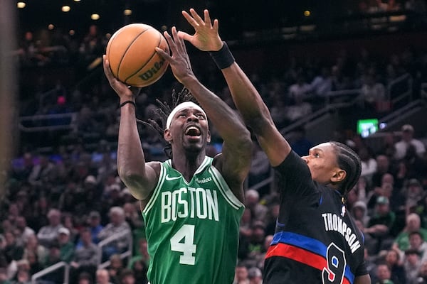 Boston Celtics guard Jrue Holiday (4) drives to the basket past Detroit Pistons forward Ausar Thompson (9) during the first half of an NBA basketball game, Thursday, Dec. 12, 2024, in Boston. (AP Photo/Charles Krupa)