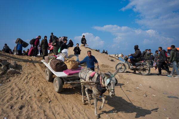 Displaced Palestinians walk on a road in central Gaza to return to their homes in the northern Gaza Strip, following the Israel-Hamas ceasefire deal, Friday, Jan. 31, 2025. (AP Photo/Abdel Kareem Hana)