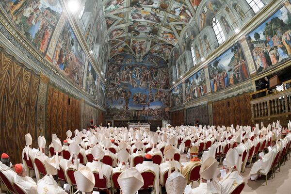 Newly elected Pope Leo XIV, seated at the back left, concelebrates Mass with the College of Cardinals inside the Sistine Chapel at the Vatican the day after his election as 267th pontiff of the Roman Catholic Church, Friday, May 9, 2025. (Vatican Media via AP)