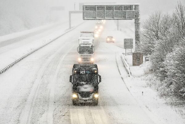 Vehicles on the A1(M) near Hopperton, north England, Sunday Jan. 5, 2025, as heavy overnight snow causes disruption across the UK as the cold start to the new year continues. (Danny Lawson/PA via AP)