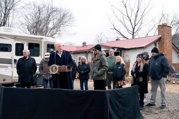 President Donald Trump, with first lady Melania Trump and Franklin Graham, left, meet with homeowners affected by Hurricane Helene in Swannanoa, N.C., Friday, Jan. 24, 2025. (AP Photo/Mark Schiefelbein)