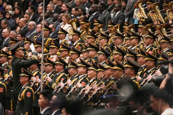 A conductor leads the military band as they perform the national anthem during the opening session of the National People's Congress (NPC) at the Great Hall of the People in Beijing, China, Wednesday, March 5, 2025. (AP Photo/Andy Wong)