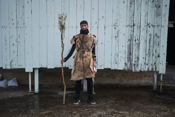 Vlasis Bellos, 19, poses for a portrait, dressed in animal skins and heavy bronze bells, as part of carnival celebrations in Distomo, a village in central Greece, on Monday, March 3, 2025. (AP Photo/Petros Giannakouris)