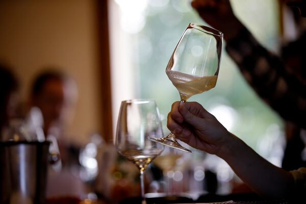 An expert wine tester shakes a glass of Prosecco during a wine testing at the Case Paolin farm, in Volpago del Montello, Italy, Monday, Oct. 15, 2018. (AP Photo/Luca Bruno, File)