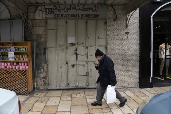 The shuttered Educational Bookshop, is seen after Israeli police raided the long-established Palestinian-owned bookstore in east Jerusalem, detaining its owners and confiscating books about the decades-long conflict saying the books incited violence, Monday, Feb. 10, 2025. (AP Photo/Mahmoud Illean)