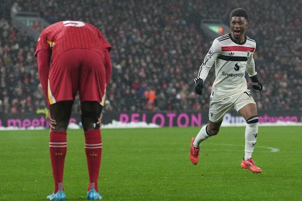 Manchester United's Amad Diallo celebrates after scoring his side's 2nd goal against Liverpool during the English Premier League soccer match at the Anfield stadium in Liverpool, England, Sunday, Jan. 5, 2025. (AP Photo/Jon Super)