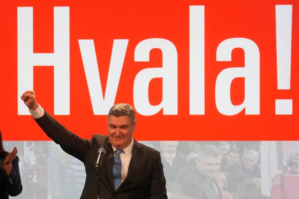 President incumbent Zoran Milanovic greets his supporters as the preliminary results grant him victory in a runoff vote for the Croatian presidential election in Zagreb, Croatia, Sunday, Jan. 12, 2025. The sign reads "Thank You". (AP Photo/Darko Bandic)