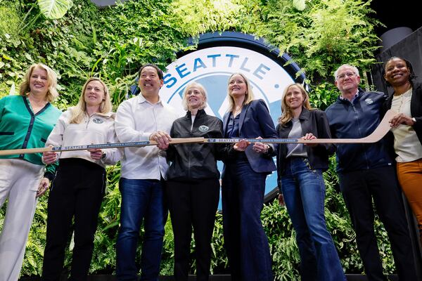 From left, President and CEO of the Seattle Sports Commission Beth Knox, PWHL Executive Vice President of Hockey Operations Jayna Hefford, Seattle Mayor Bruce Harrell, PWHL Executive Vice President of Business Operations Amy Scheer, King County Executive Shannon Braddock, Seattle Kraken co-owner Samantha Holloway, Seattle Kraken CEO Tod Leiweke and Seattle council member Joy Hollingsworth pose for a group photo after a press conference announcing the new PWHL expansion team Wednesday, April 30, 2025, in Seattle. (Jennifer Buchanan/The Seattle Times via AP)