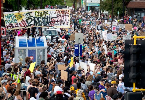 FILE - Protesters gather calling for justice for George Floyd on Tuesday, May 26, 2020, in Minneapolis. Four Minneapolis officers involved in the arrest of Floyd, a black man who died in police custody, were fired Tuesday, hours after a bystander's video showed an officer kneeling on the handcuffed man's neck, even after he pleaded that he could not breathe and stopped moving. (Carlos Gonzalez/Star Tribune via AP, file)
