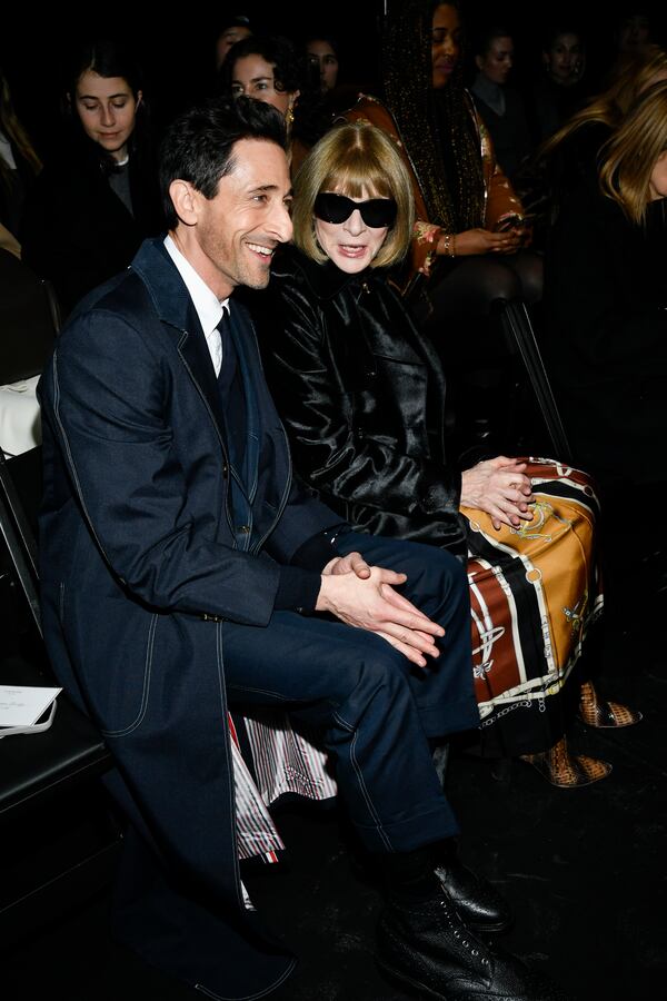 Adrien Brody, left, and Anna Wintour attend the Thom Browne Fall/Winter 2025 fashion show as part of New York Fashion Week on Tuesday, Feb. 11, 2025, at The Shed in New York. (Photo by Evan Agostini/Invision/AP)