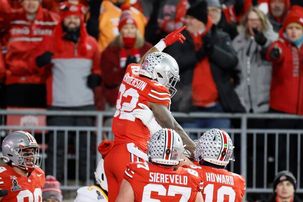 FILE - Ohio State running back TreVeyon Henderson, top, celebrates after his touchdown against Tennessee during the first half in the first round of the College Football Playoff, Saturday, Dec. 21, 2024, in Columbus, Ohio. (AP Photo/Jay LaPrete, File)