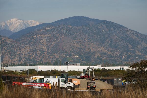 Construction workers set up gravel to prevent ground contamination at the grounds of Lario Park to be used by the U.S. Environmental Protection Agency (EPA) temporarily for processing hazardous materials from the Eaton Fire, in Irwindale, Calif., Friday, Jan. 31, 2025. (AP Photo/Damian Dovarganes)