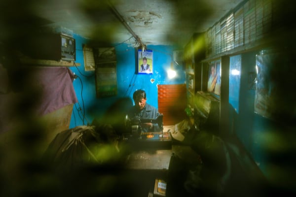 Farooq Ahmad Shaksaaz listens to his favorite Sufi singer as he works at his tailor shop in the outskirts of Srinagar, Indian controlled Kashmir, Friday, Feb. 14, 2025. (AP Photo/Dar Yasin)