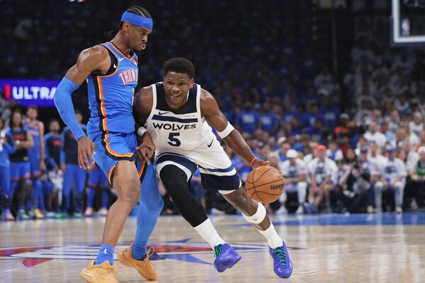 Minnesota Timberwolves guard Anthony Edwards (5) works toward the basket as Oklahoma City Thunder guard Shai Gilgeous-Alexander (2) defends during the first half of Game 5 of the Western Conference finals of the NBA basketball playoffs, Wednesday, May 28, 2025, in Oklahoma City. (AP Photo/Nate Billings)