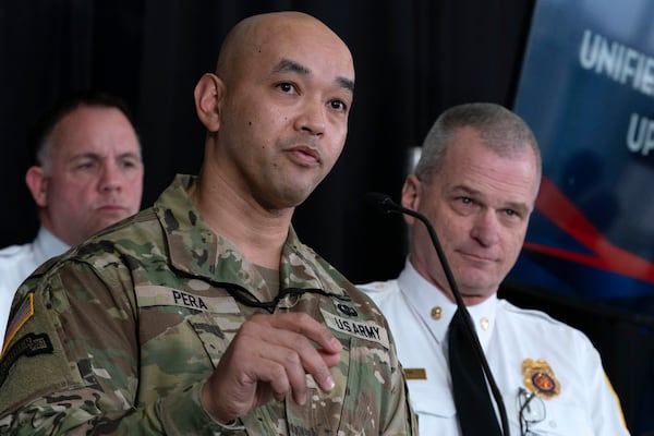 Col. Francis Pera, commander of the U.S. Army Corps of Engineers speaks as D.C. Fire and EMS Chief John Donnelly, right, listens during a news conference at Ronald Reagan Washington National Airport, Sunday, Feb. 2, 2025, in Arlington, Va. (AP Photo/Jose Luis Magana)