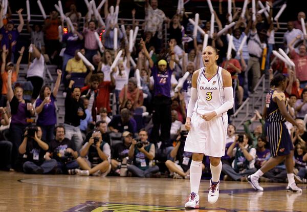 FILE - Phoenix Mercury guard Diana Taurasi (3) celebrates her score against the Indiana Fever as fans cheer in the second quarter of Game 5 of the WNBA basketball finals Friday, Oct. 9, 2009, in Phoenix. (AP Photo/Paul Connors, File)