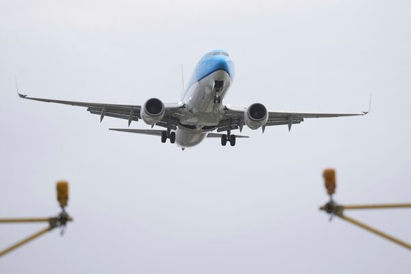 An aeroplane lands in gusty conditions at Heathrow Airport in London, Friday, Jan. 24, 2025, as storm Eowyn disrupts travel the British Isles. (AP Photo/Alastair Grant)