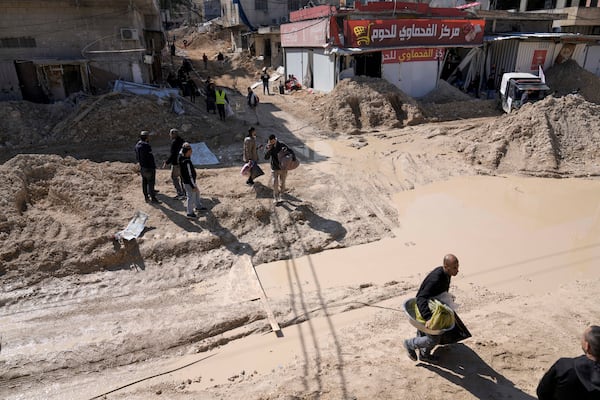 Residents of the West Bank urban refugee camp of Nur Shams evacuate their homes and carry their belongings as the Israeli military continues its operation in the area on Wednesday, Feb. 26, 2025. (AP Photo/Majdi Mohammed)