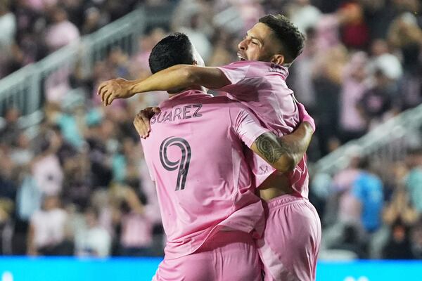 Inter Miami defender Jordi Alba, right, celebrates with forward Luis Suárez (9) after scoring a goal during the first half of a CONCACAF Champions Cup second-leg semifinal soccer match against the Vancouver Whitecaps, Wednesday, April 30, 2025, in Fort Lauderdale, Fla. (AP Photo/Lynne Sladky)