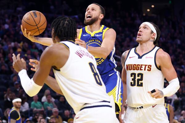 Golden State Warriors' Stephen Curry drives past Denver Nuggets' Aaron Gordon in second quarter of their NBA game at Chase Center in San Francisco on Monday, March 17, 2025. (Scott Strazzante/San Francisco Chronicle via AP)