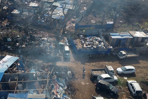 A man walks in the Barakani, Mayotte, informal settlement, Saturday, Dec. 21, 2024. (AP Photo/Adrienne Surprenant)