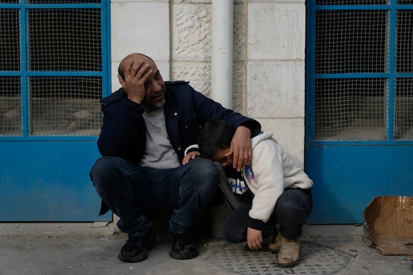 Mourners wait outside the morgue for the funeral of six Palestinians who were killed during an Israeli airstrike on Wednesday, in the West Bank refugee camp of Jenin Thursday, Jan. 16, 2025. (AP Photo/Nasser Nasser)