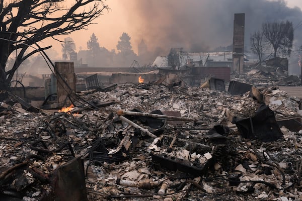 The Palisades Fire ravages a neighborhood amid high winds in the Pacific Palisades neighborhood of Los Angeles, Wednesday, Jan. 8, 2025. (AP Photo/Damian Dovarganes)