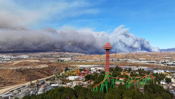 The tower at Six Flags Magic Mountain with the Hughes fire burning in Castaic on Wednesday, Jan. 22, 2025. (Dean Musgrove/The Orange County Register via AP)