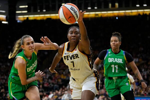 Indiana Fever center Aliyah Boston (7) fights for the ball with Brazil center Izabel de Angelo, left, during the first half of an exhibition women's basketball game, Sunday, May 4, 2025, in Iowa City, Iowa. (AP Photo/Charlie Neibergall)