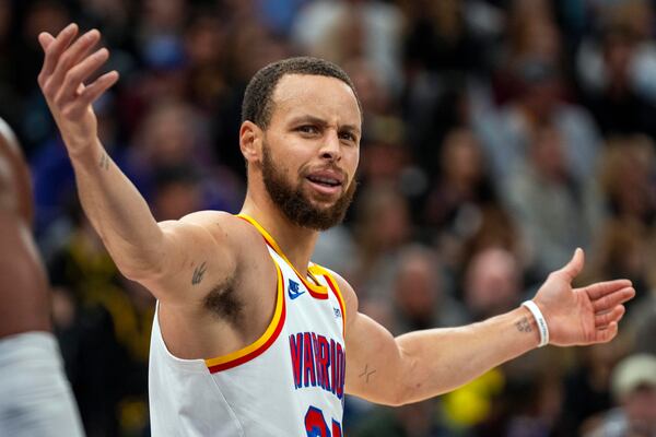 Golden State Warriors guard Stephen Curry looks at the official, during the first half of an NBA basketball game against the Utah Jazz Wednesday, Feb. 5, 2025, in Salt Lake City. (AP Photo/Rick Egan)