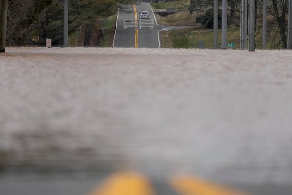 A vehicle drives the opposite direction of a road closure sign along Dunbar Cave Rd., Sunday, Feb. 16, 2025, in Clarksville, Tenn. (AP Photo/George Walker IV)