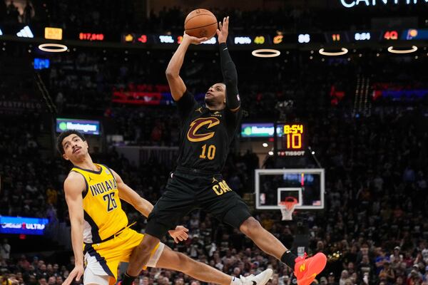 Cleveland Cavaliers guard Darius Garland, right, shoots as Indiana Pacers guard Ben Sheppard defends during the second half in Game 5 of an Eastern Conference semifinal NBA basketball playoff Tuesday, May 13, 2025, in Cleveland. (AP Photo/Sue Ogrocki)