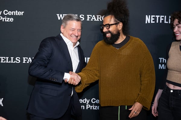 Netflix co-CEO Ted Sarandos, left, shakes hands with Reggie Watts as they arrive at the 25th Annual Mark Twain Prize for American Humor Celebrating Conan O'Brien, Sunday, March 23, 2025, at the Kennedy Center for the Performing Arts in Washington. (AP Photo/Kevin Wolf)