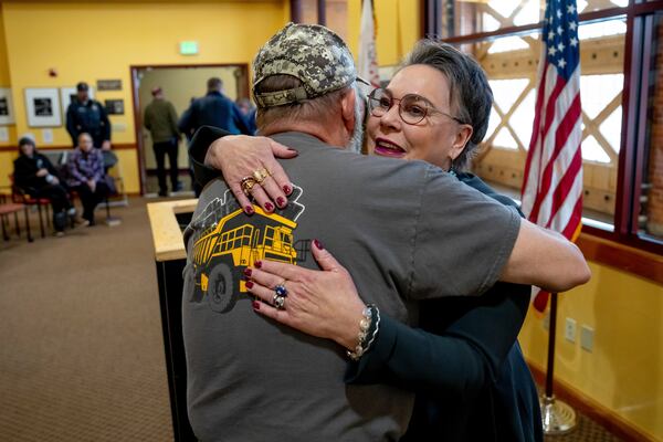 Rep. Harriet Hageman, R-Wyo., right, hugs Karl Allred, former secretary of state of Wyoming, before Hageman holds a town hall meeting on Friday, March 14, 2025, in Evanston, Wyo. (AP Photo/Spenser Heaps)