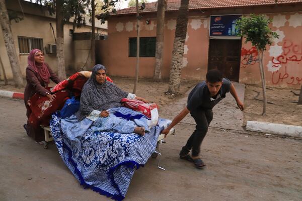 Palestinians evacuate patients from the European hospital in Khan Younis, Gaza, after it was hit by an Israeli army airstrike, Tuesday, May 13, 2025. The Israeli military said it had carried out a strike targeting what it said was a Hamas "command and control center" located beneath the hospital. (AP Photo/Mariam Dagga)
