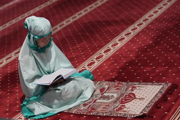 A Muslim woman reads Quran during the first day of the holy fasting month of Ramadan at Istiqlal mosque in Jakarta, Indonesia, Saturday, March 1, 2025. (AP Photo/Achmad Ibrahim)