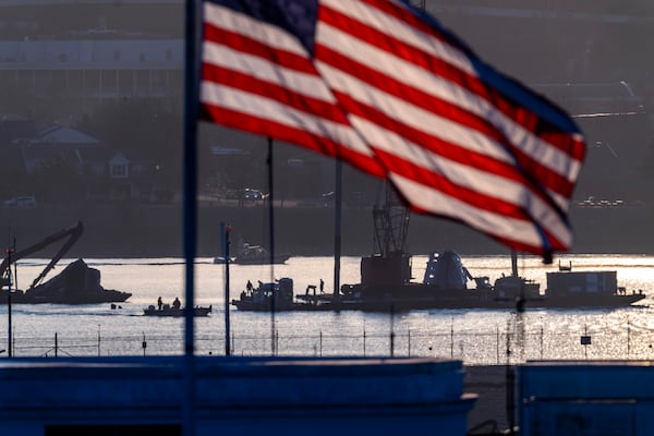 Salvage crews work near the wreckage site in the Potomac River of a mid-air collision between an American Airlines jet and a Black Hawk helicopter, at Ronald Reagan Washington National Airport, Tuesday, Feb. 4, 2025, in Arlington, Va. (AP Photo/Ben Curtis)