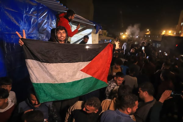 Palestinians celebrate the imminent announcement of a ceasefire deal between Hamas and Israel in Khan Younis, central Gaza Strip, Wednesday, Jan. 15, 2025.(AP Photo/(AP Photo/Mariam Dagga)