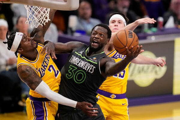 Minnesota Timberwolves forward Julius Randle (30) drives to the basket as Los Angeles Lakers forward Jarred Vanderbilt (2) defends during the first half in Game 5 of an NBA basketball first-round playoff series Wednesday, April 30, 2025, in Los Angeles. (AP Photo/Mark J. Terrill)