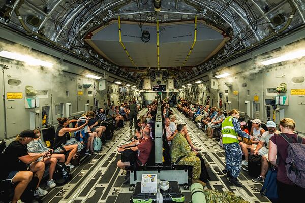 This photo released by Australian Department of Defence, shows Australian citizens on board a Royal Australian Air Force aircraft for a flight home from Bauerfield International Airport, Port Vila, Vanuatu, Wednesday, Dec. 18, 2024 following a powerful earthquake that struck just off the coast of Vanuatu in the South Pacific Ocean. (CPL Adam Abela/Australian Department of Defence via AP)