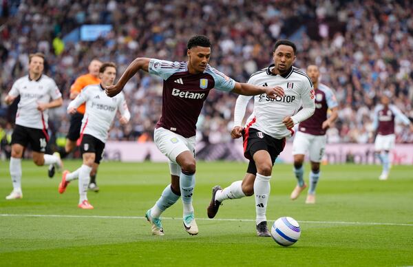 Aston Villa's Ollie Watkins, centre, and Fulham's Kenny Tete battle for the ball during the English Premier League soccer match between Aston Villa and Fulham at Villa Park, Birmingham, England, Saturday, May 3, 2025. (Nick Potts/PA via AP)