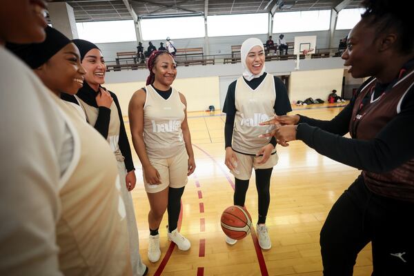 Players, some wearing headscarves, huddle during competition in Aubervilliers near Paris, Sunday, April 27, 2025. (AP Photo/Thomas Padilla)